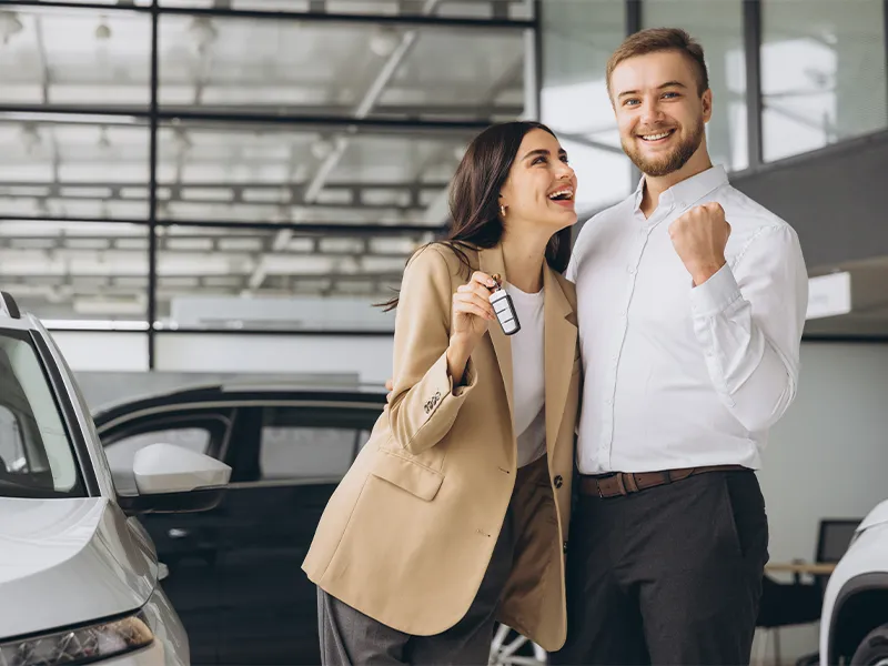 Couple shaking hands with sales person