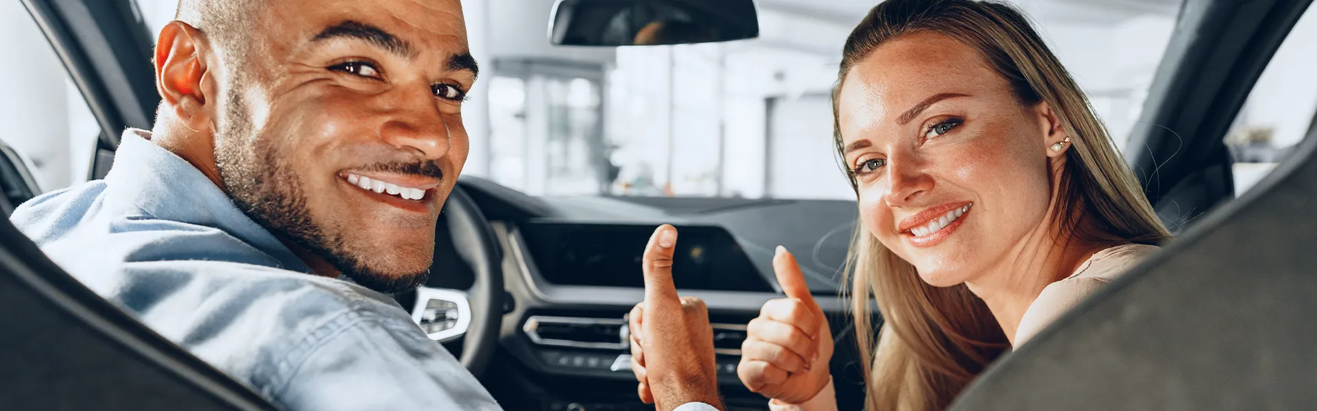 Customer examining a used car interior